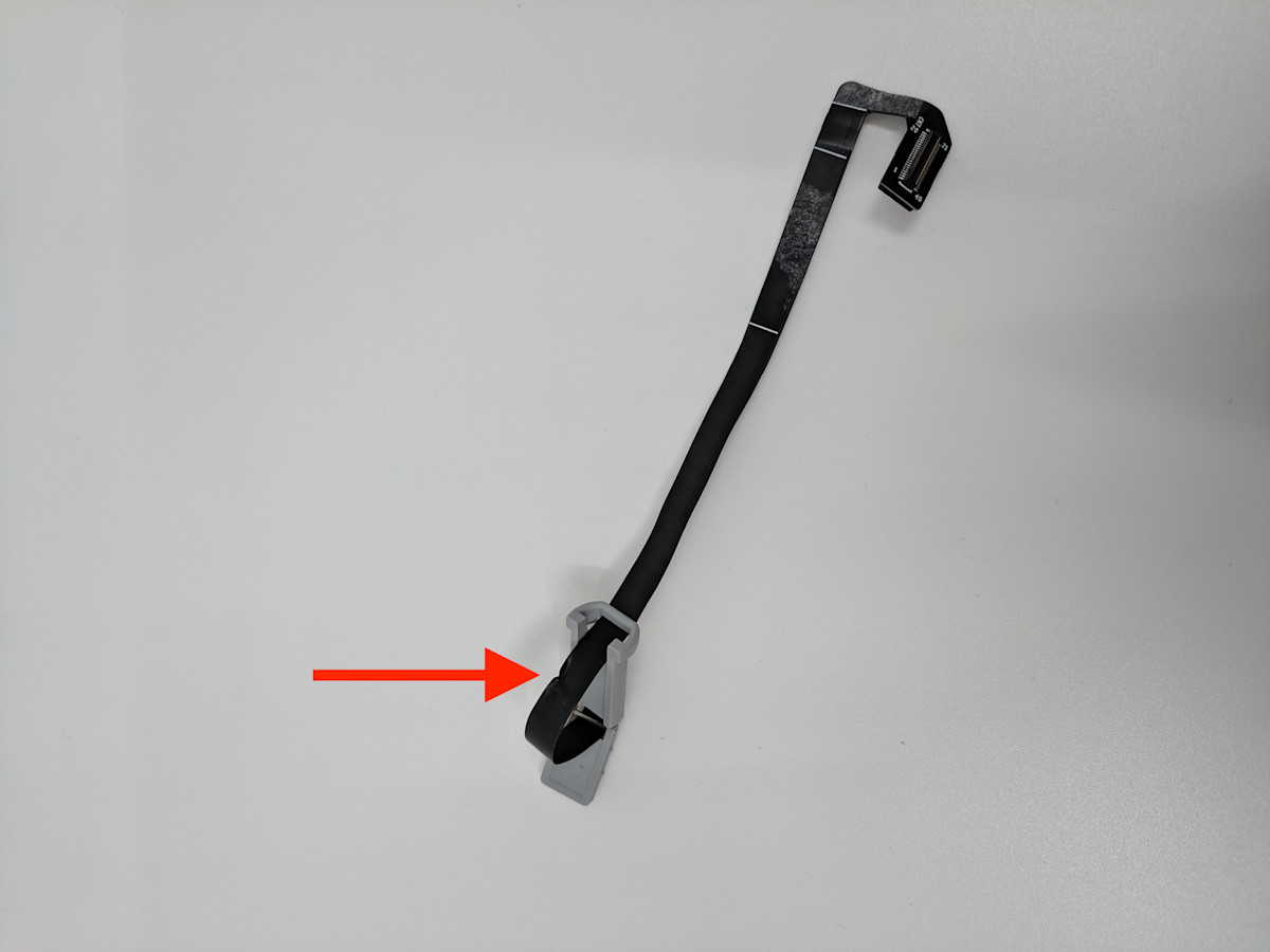 red arrow pointing to a dent in the flex cable