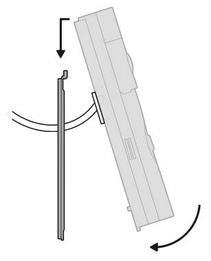 Illustration showing how to mount the doorbell by hooking it to the bracket and pushing downwards.