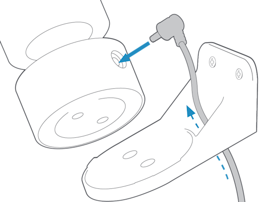 The power cable for the Pan-Tilt mount with an arrow leading it through the hole on the wall mount and into the port on the back of the Stick Up Cam.