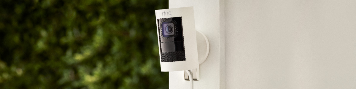 Ring Stick Up Cam Elite plugged into ethernet and mounted to backyard wall