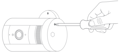 Illustration of how to access the security screw at the battery compartment of the Outdoor Cam when the device is mounted to a wall. 