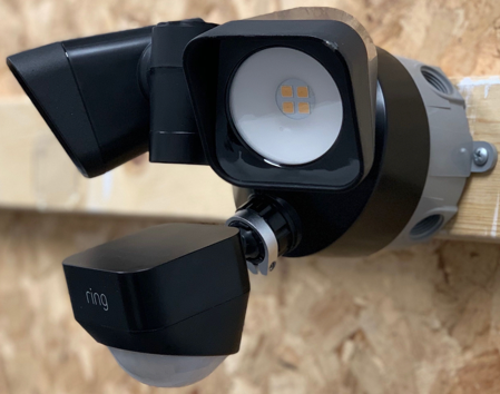 Ring security floodlight camera mounted on exterior wall
