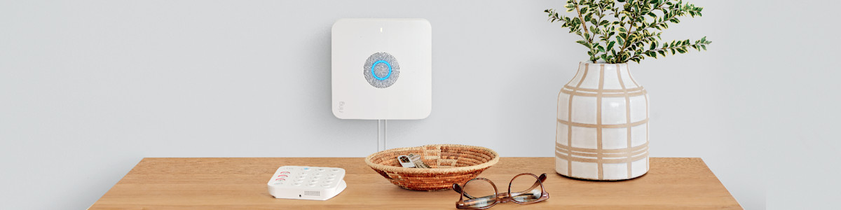 Ring Alarm Pro mounted on the wall above a console table in a modern home.