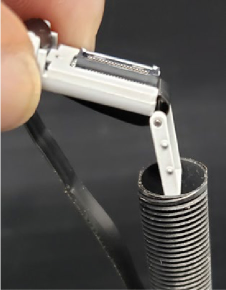 Taking the connector at the end of the new cable and placing in tube.