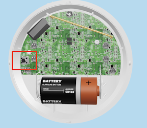 Illustration showing the location of the setup button under the cover of the Flood & Freeze Sensor.