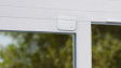 A Ring Alarm Contact Sensor protecting a window inside a modern home.