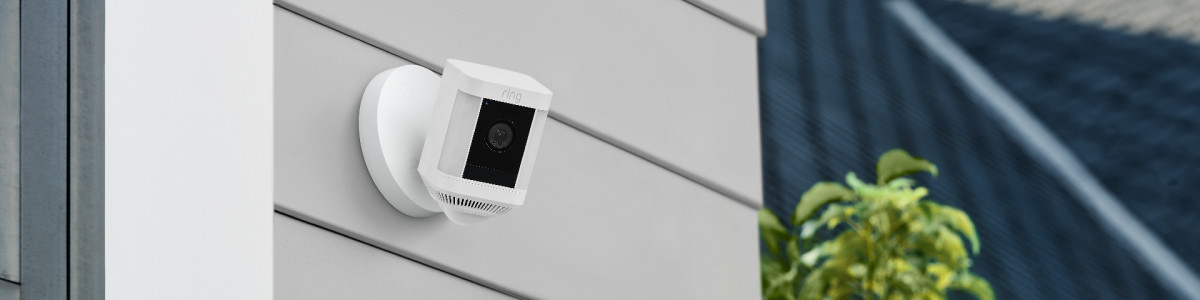 Ring Spotlight Cam Plus Wired mounted on a wall outside ready to protect