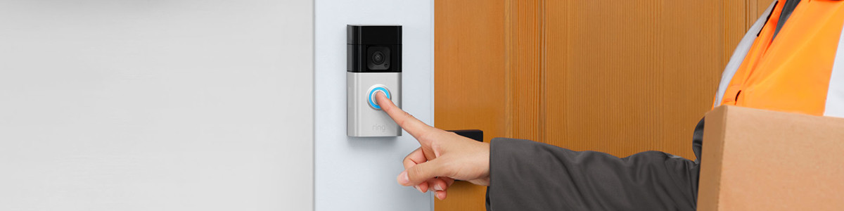 A delivery person pressing Ring Battery Doorbell Plus at someone's front door