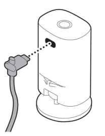 Illustration showing to plug the power cord into the camera.