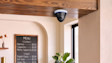 The Dome Cam 4K mounted on a ceiling in a business location.