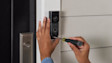 Image showing a home owner installing Battery Doorbell Plus (2nd Gen).