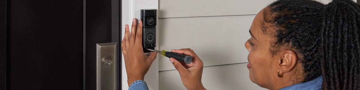 Image showing a home owner installing Battery Video Doorbell Plus (2nd Gen).