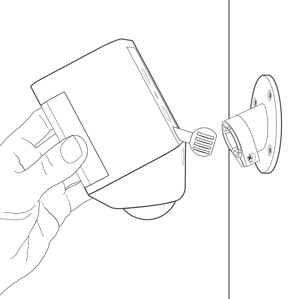 A hand holding a Spotlight Cam inserting the plug into the mounting bracket on the wall.