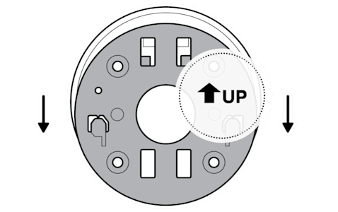 A gray camera mounting plate with a white circle behind it and an arrow pointing up on it and two arrows pointing down next to it showing to slide it off.