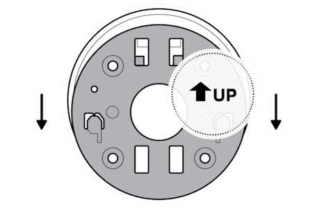 A gray camera mounting plate with a white circle behind it and an arrow pointing up on it and two arrows pointing down next to it showing to slide it off.