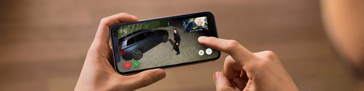 A homeowner using Live View in the Ring App to speak to someone in their driveway 