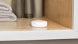Image showing the Flood and Freeze Sensor in a modern bathroom cabinet.