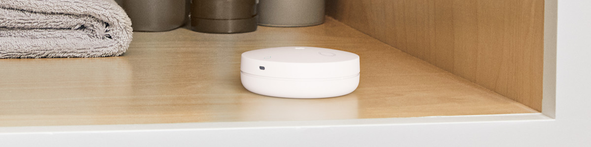 Image showing the Flood and Freeze Sensor in a modern bathroom cabinet.
