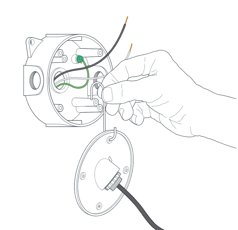 A junction box with a green wire and black wire coming out of it, and a hand hanging the cover using the included hook.