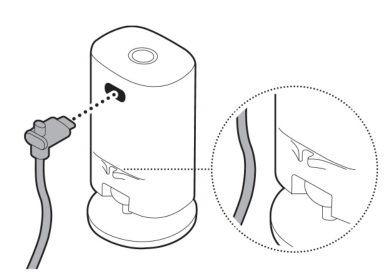 Illustration showing to secure the power cable into the clip on the base of the camera.