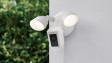 Ring Floodlight Cam Plus outside with its bright, motion-activated LED lights turned on at sunrise